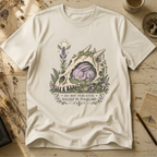 Vintage white t-shirt with an illustration of a horned, fanged skull overgrown with moss and lavender, a sleeping purple stitched rabbit curled inside it, and a small ghost hovering above.
