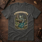 Asphalt grey t-shirt with an ornate illustration of a pale blue water dragon spirit resting on a moss-covered stone fountain among lily pads and koi.