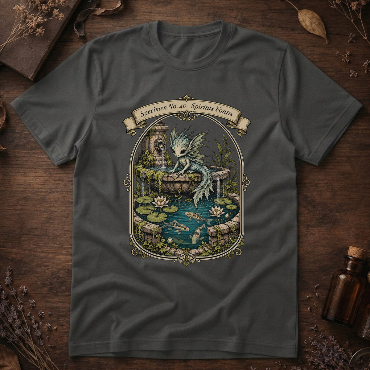 Asphalt grey t-shirt with an ornate illustration of a pale blue water dragon spirit resting on a moss-covered stone fountain among lily pads and koi.