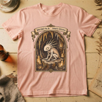 Peach t-shirt with a gothic illustration of a horned, single-eyed cave spirit perched on glowing crystal formations inside an arched cavern frame.