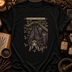 Black t-shirt with a botanical illustration of a hanging bat spirit among wisteria blossoms and bees, framed by a Specimen No. 19 banner.