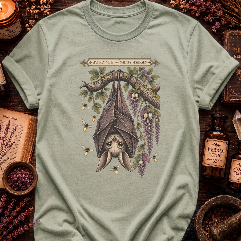 Sage green t-shirt with a botanical illustration of a hanging bat spirit among wisteria blossoms and bees, framed by a Specimen No. 19 banner.