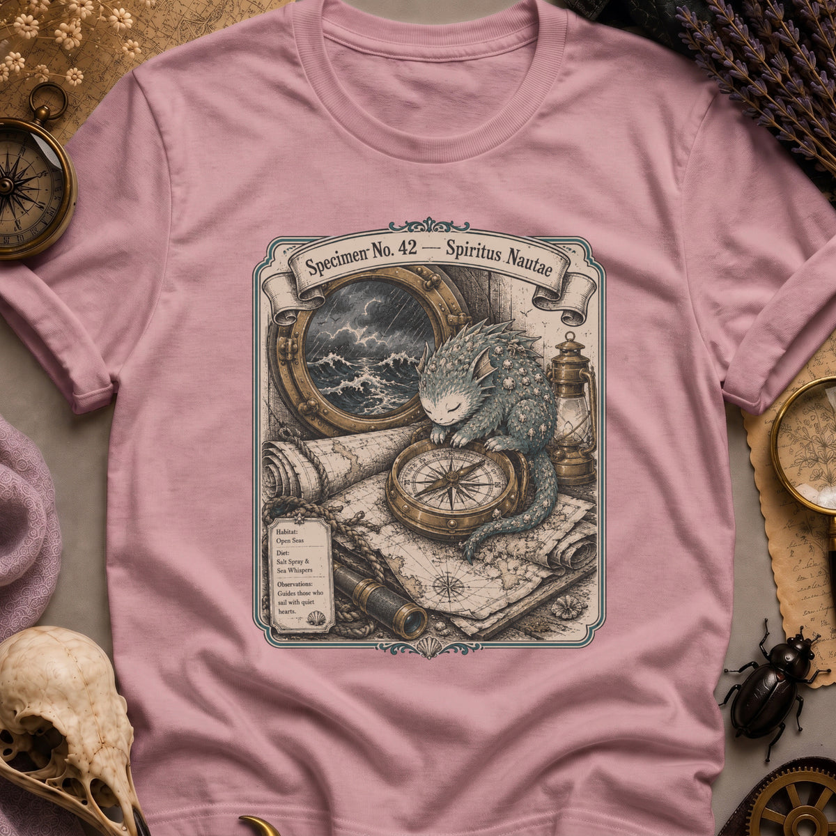 Orchid pink t-shirt with a sepia-toned illustration of a sea spirit resting a paw on a brass compass atop an antique nautical map, with a stormy porthole scene above.