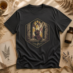Vintage black t-shirt with a stained-glass window illustration of a small hooded spirit sitting before a Gothic arched window in yellow, purple, and blue glass panels.