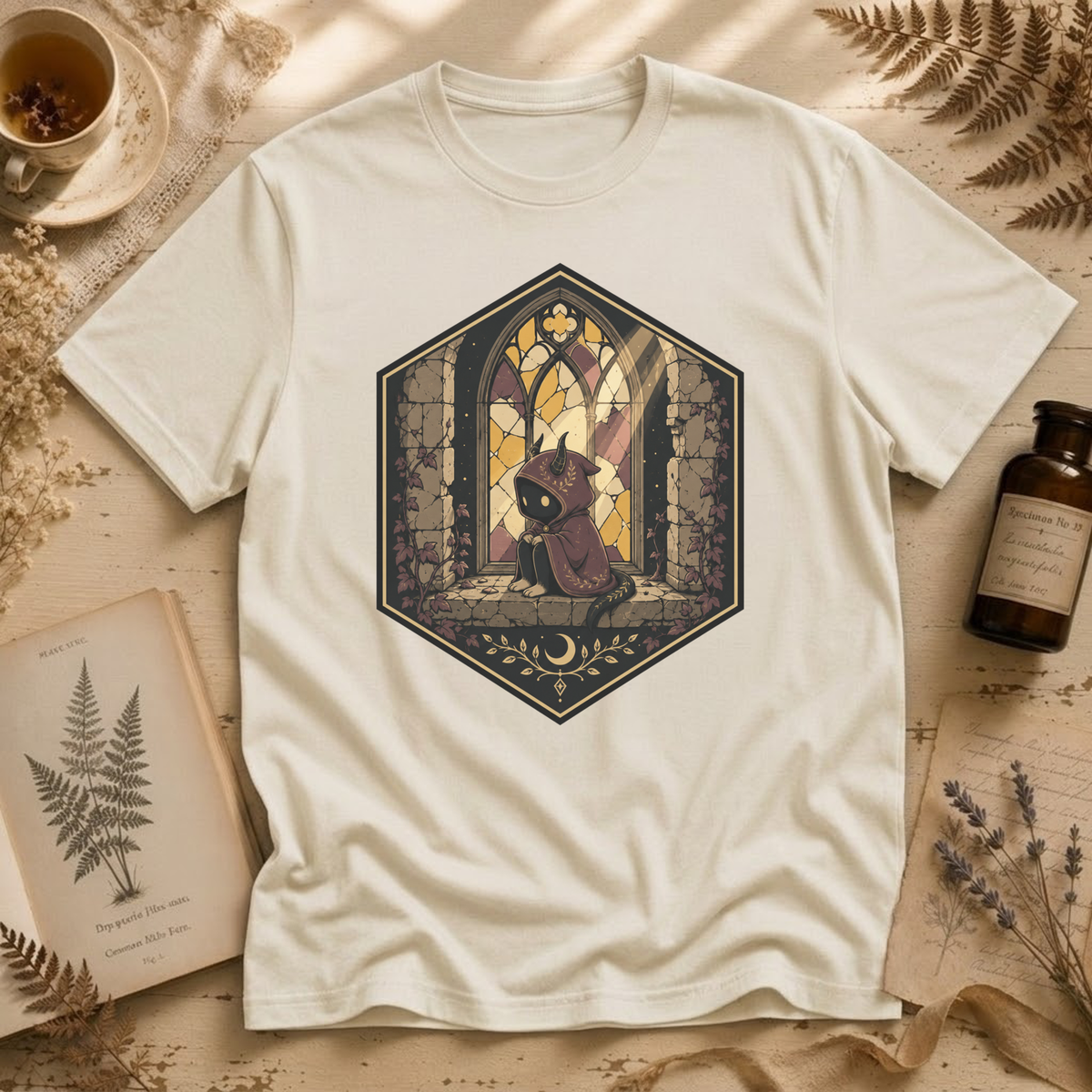 Vintage white t-shirt with a stained-glass window illustration of a small hooded spirit sitting before a Gothic arched window in yellow, purple, and blue glass panels.