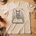 Vintage white t-shirt with a botanical illustration of a skull-faced spirit wearing a floral crown, standing among lavender and bluebell flowers between two open books.