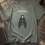 Sage green t-shirt with a gothic illustration of a raven-winged spirit sitting on a bare branch, holding a glowing lantern, beneath a crescent moon banner reading Specimen No. 56.
