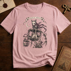 Orchid pink t-shirt with a gothic illustration of a skeletal cat spirit with a flowing scarf riding an old mechanical ferris wheel beneath a crescent moon.