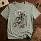 Sage green t-shirt with a gothic illustration of a skeletal cat spirit with a flowing scarf riding an old mechanical ferris wheel beneath a crescent moon.