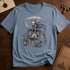 Steel blue t-shirt with a gothic illustration of a skeletal cat spirit with a flowing scarf riding an old mechanical ferris wheel beneath a crescent moon.